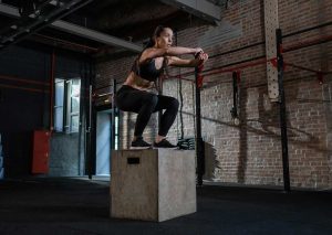 Female doing step ups during HIIT training